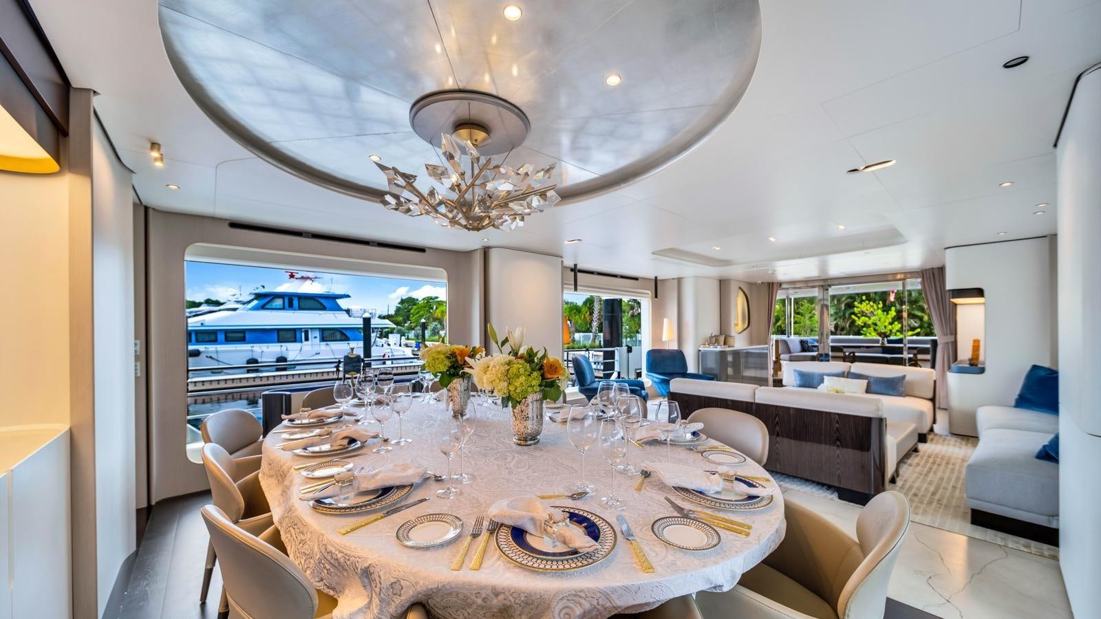 a large dining room with a chandelier aboard ONE & ONLY Yacht for Sale