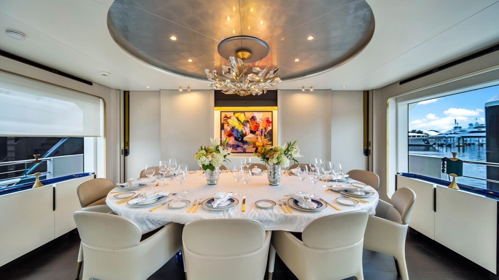a dining room with a large window aboard ONE & ONLY Yacht for Sale