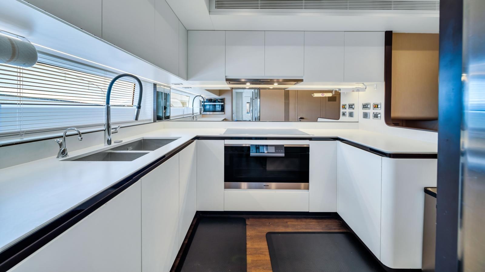 a kitchen with white cabinets aboard ONE & ONLY Yacht for Sale