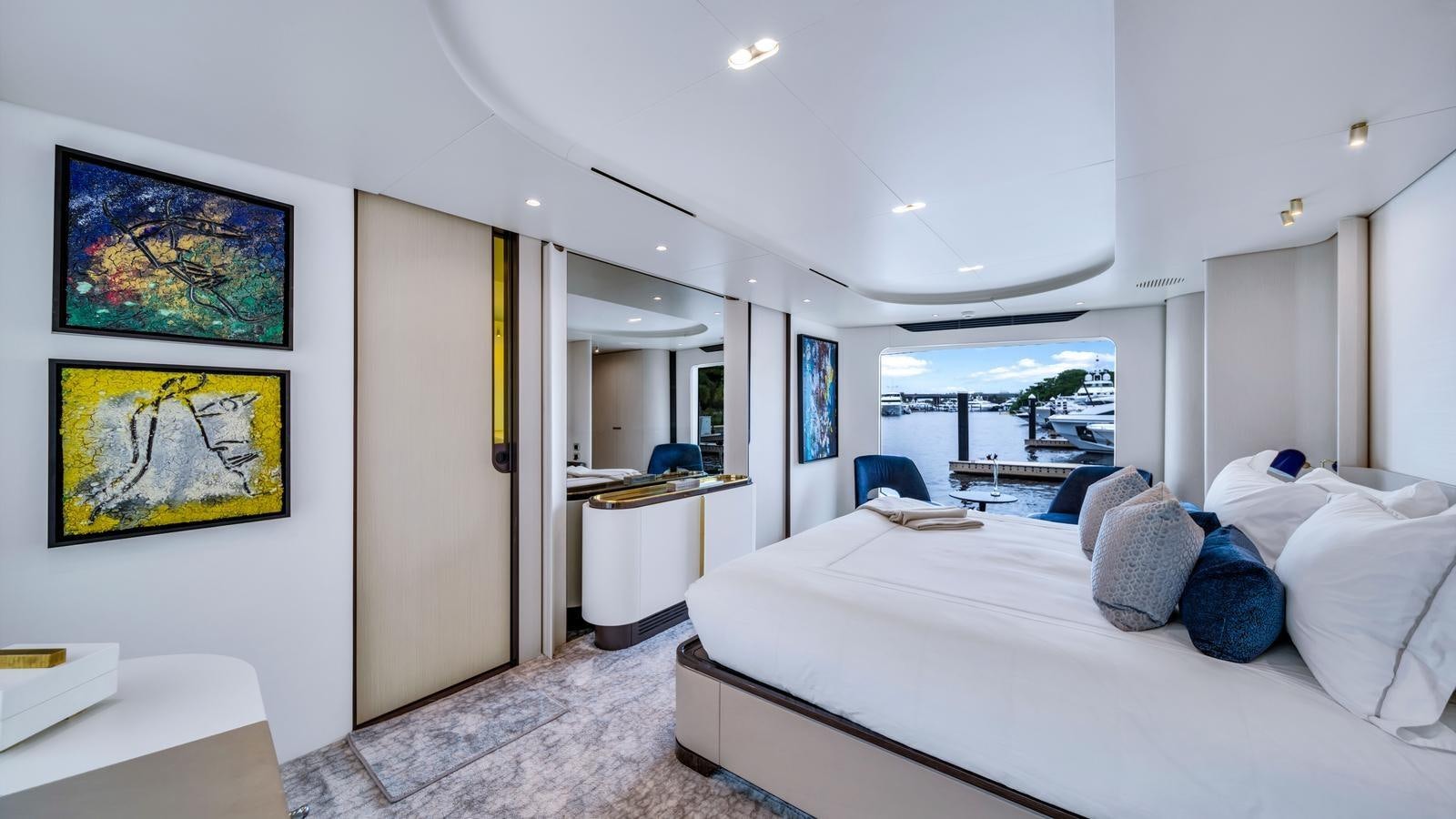 a room with a bed and a desk aboard ONE & ONLY Yacht for Sale