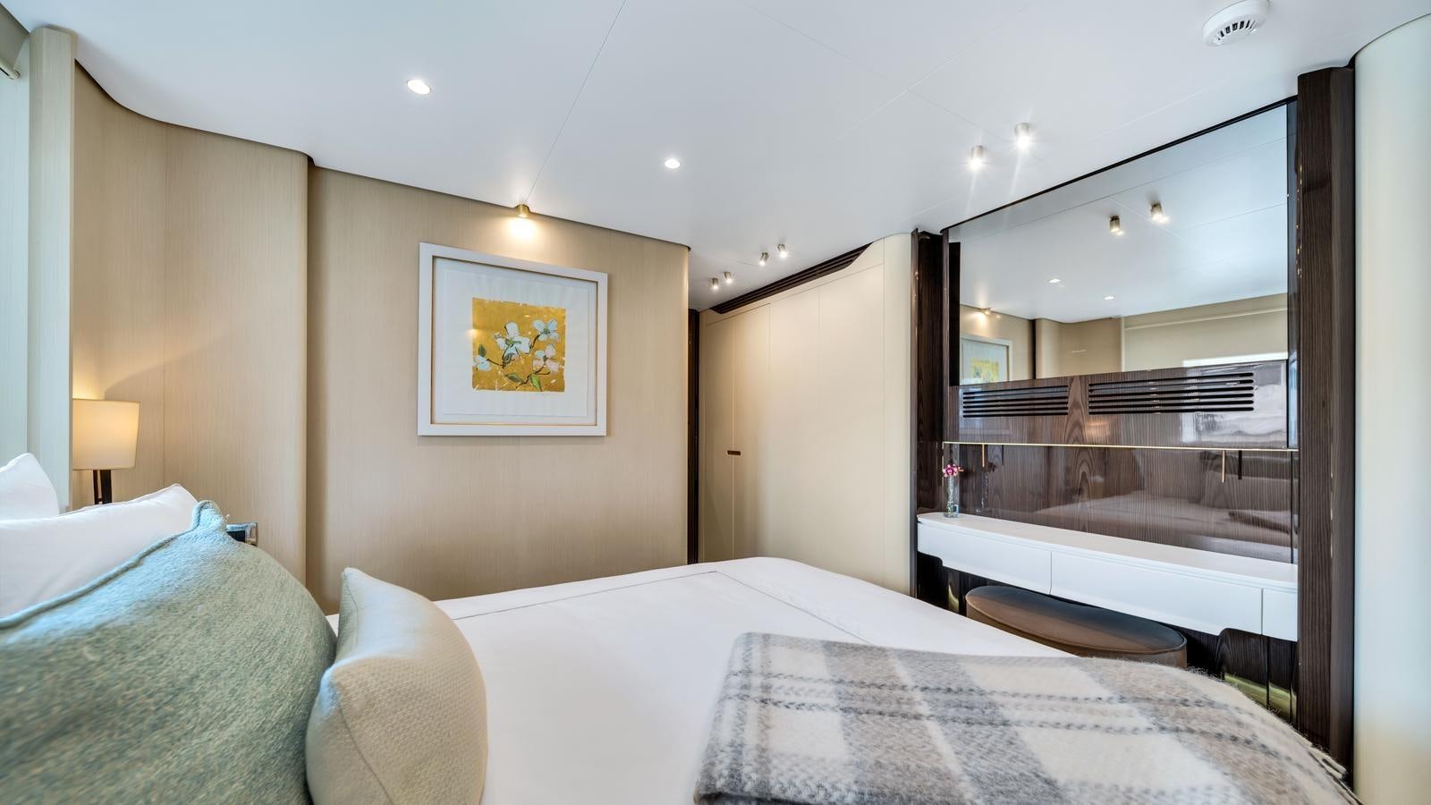 a hotel room with a large mirror aboard ONE & ONLY Yacht for Sale