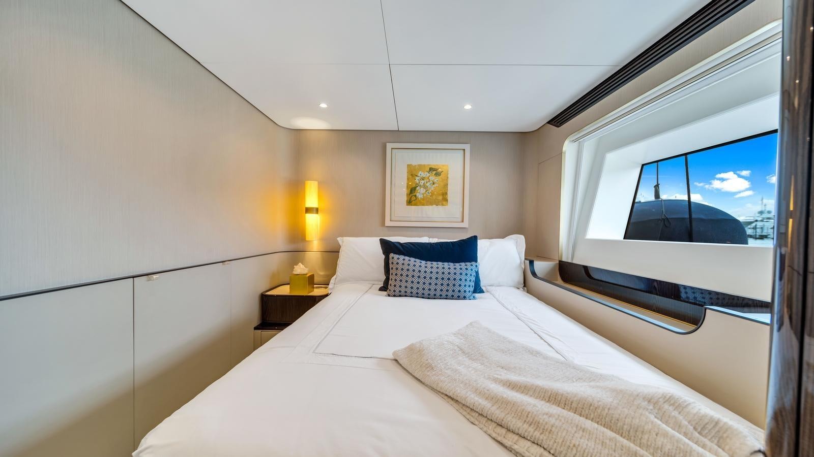 a hotel room with a large window aboard ONE & ONLY Yacht for Sale