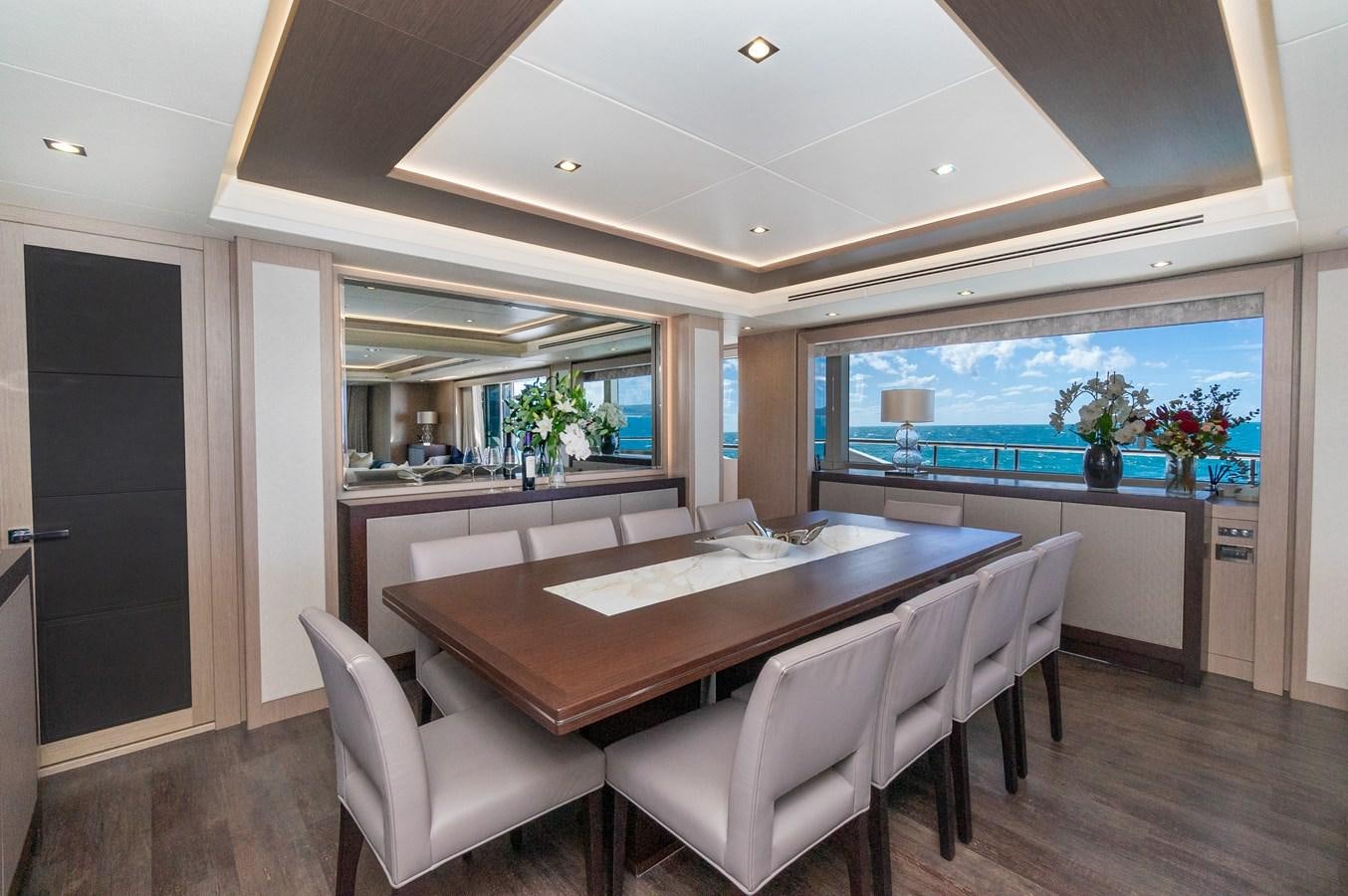a large dining table in a room aboard POPS Yacht for Sale