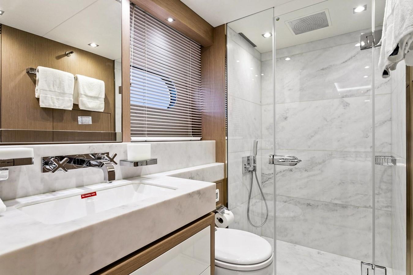 a bathroom with a glass shower aboard POPS Yacht for Sale