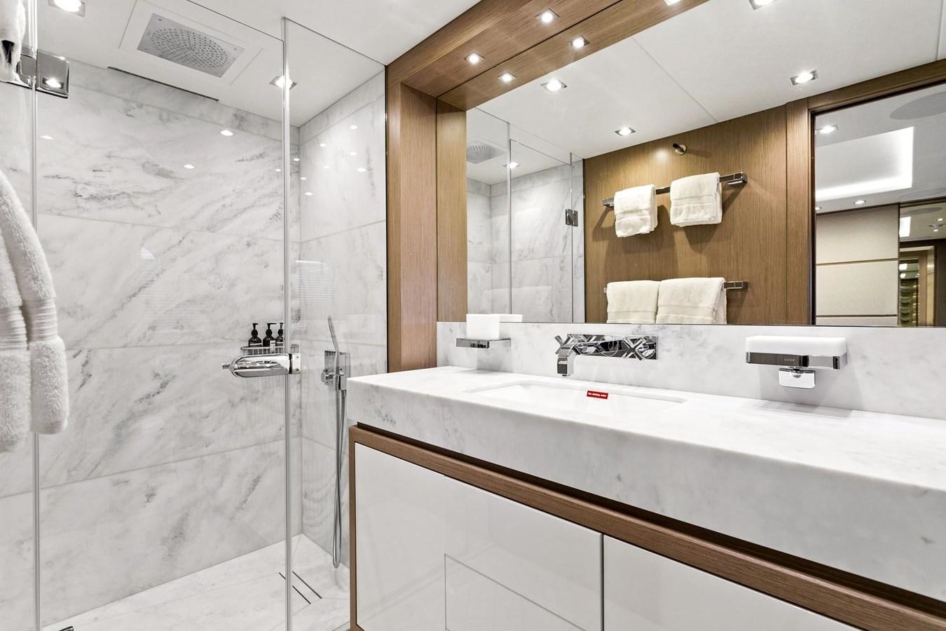 a bathroom with a large mirror aboard POPS Yacht for Sale