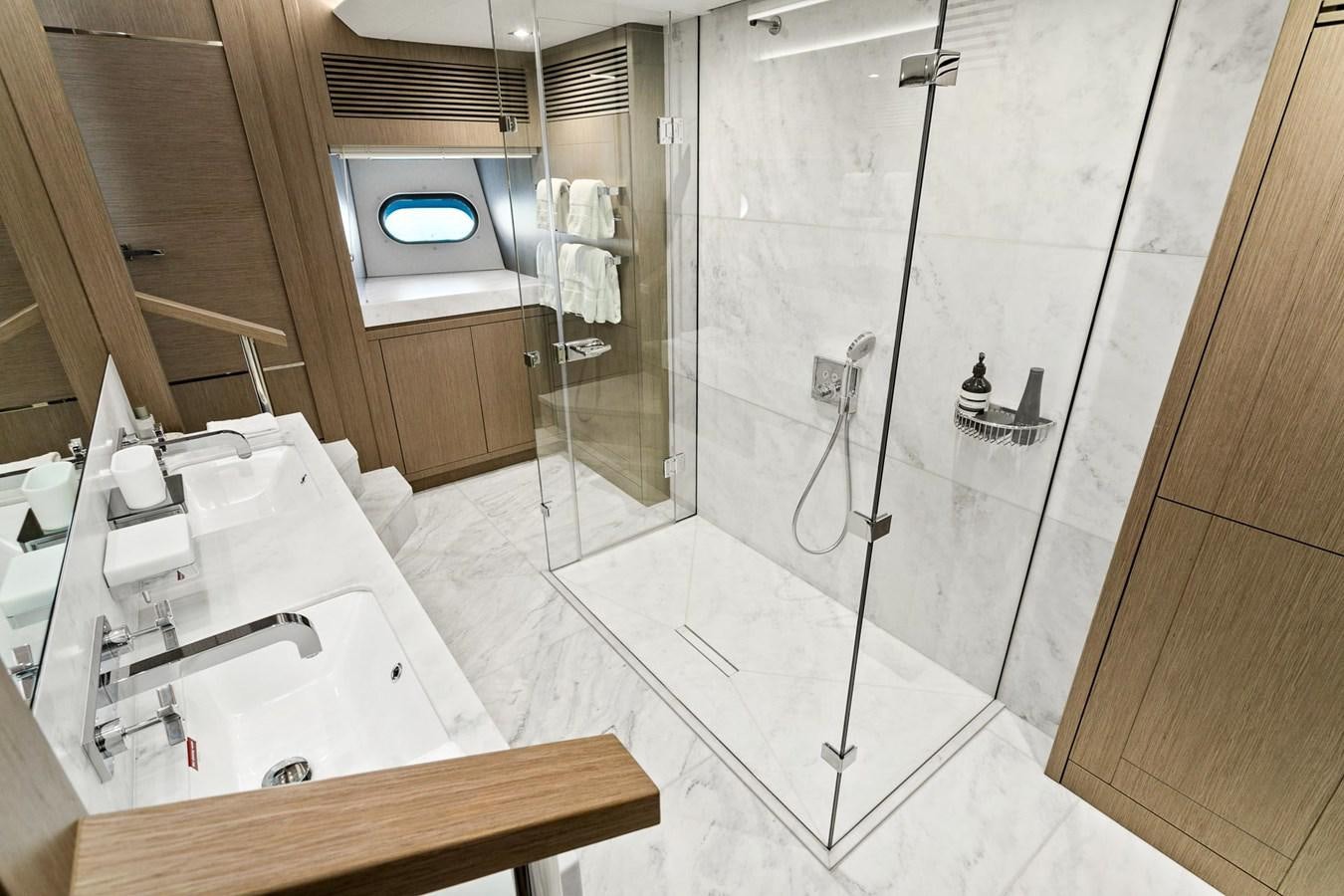 a bathroom with a shower unit and sink aboard POPS Yacht for Sale
