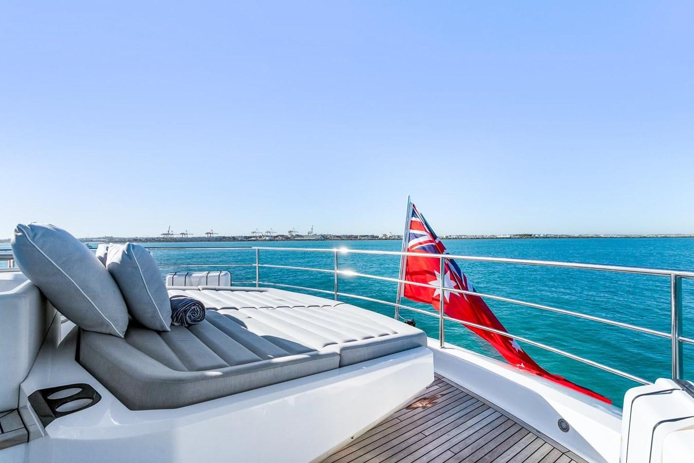 a boat with a flag on the front aboard POPS Yacht for Sale