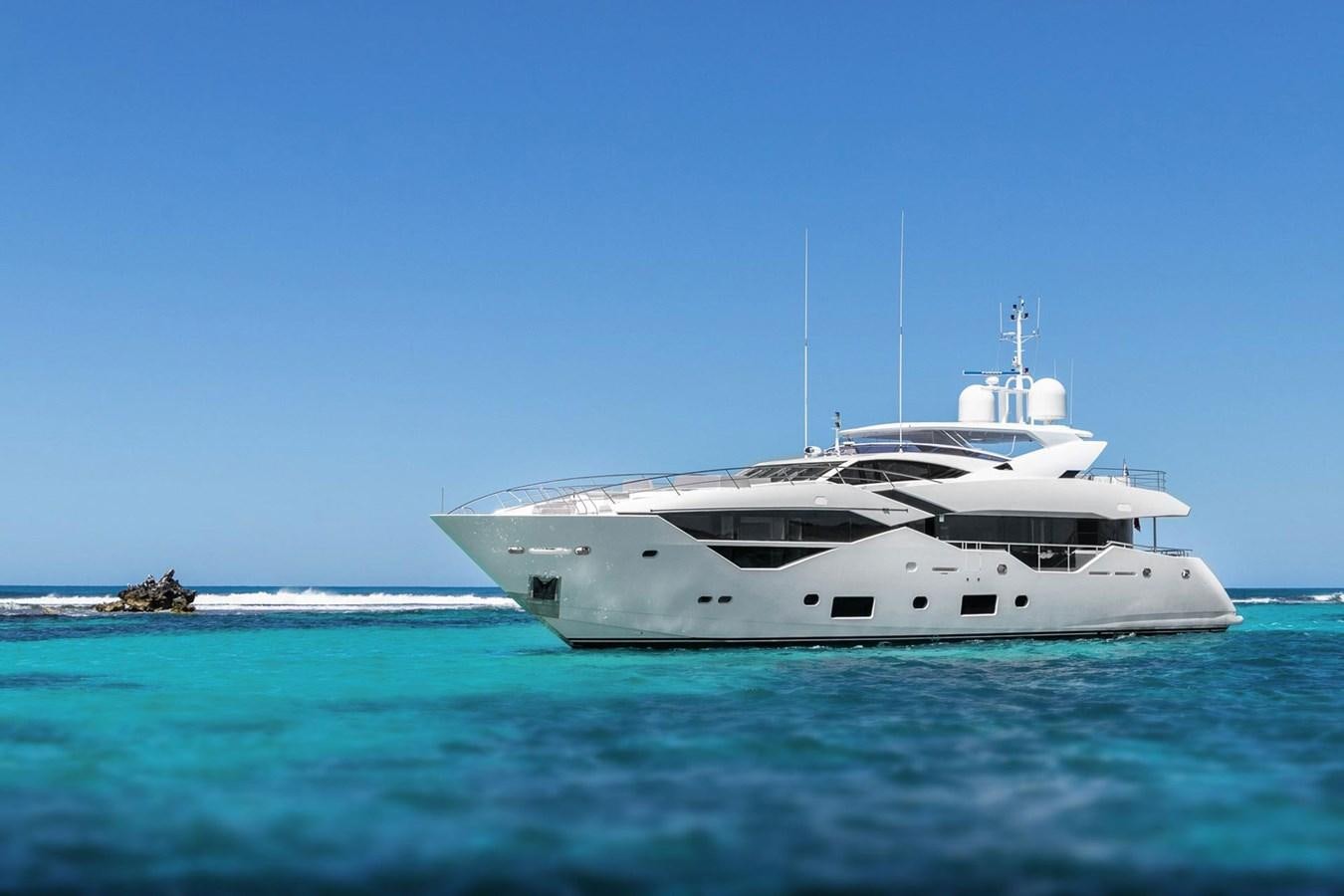 a white yacht in the water aboard POPS Yacht for Sale