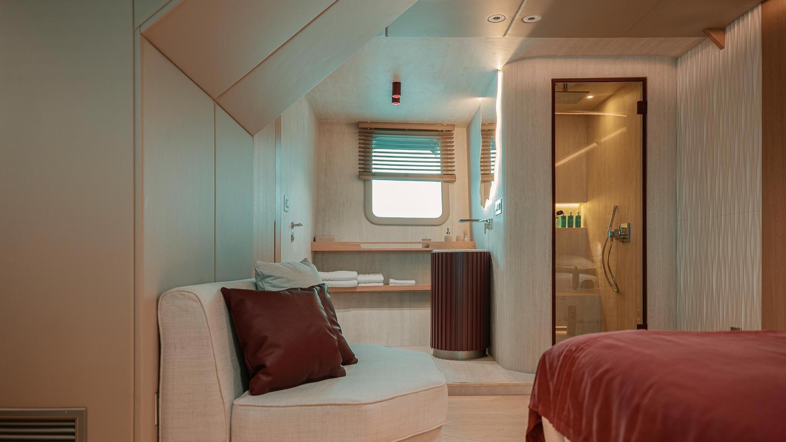 a bedroom with a bed and a window aboard REPOSADO Yacht for Sale