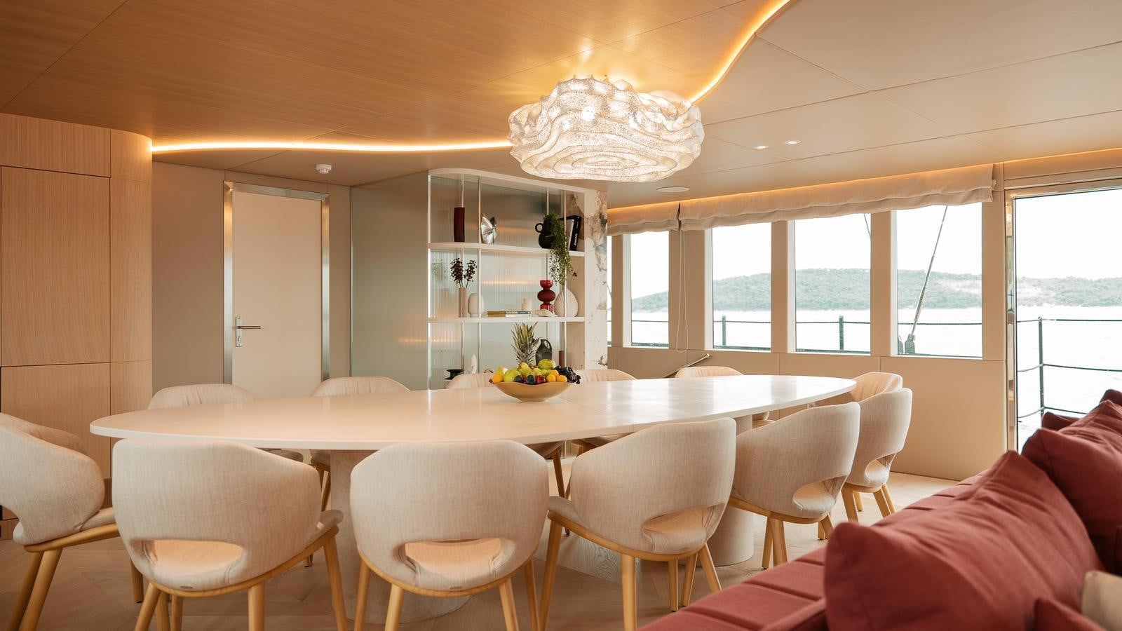 a large dining room with white chairs aboard REPOSADO Yacht for Sale