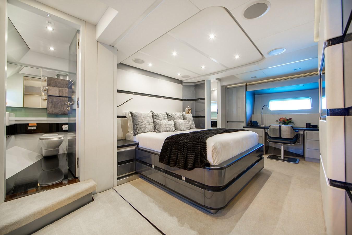a bedroom with a bed and a large mirror aboard BLISS Yacht for Sale