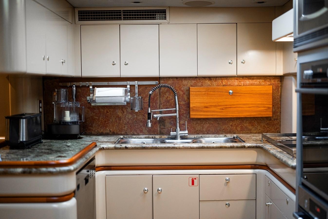 a kitchen with white cabinets aboard ECLIPSE Yacht for Sale