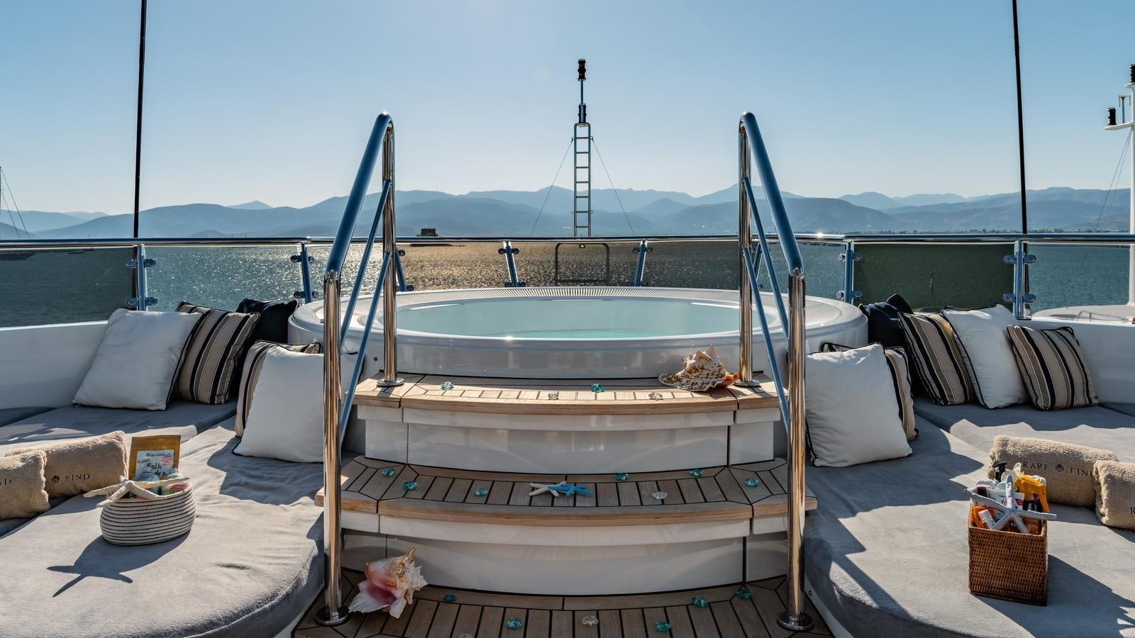 a pool with a deck and a tower in the background aboard RARE FIND Yacht for Sale