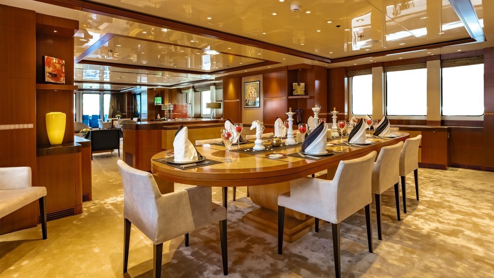 a large room with a table and chairs aboard RARE FIND Yacht for Sale