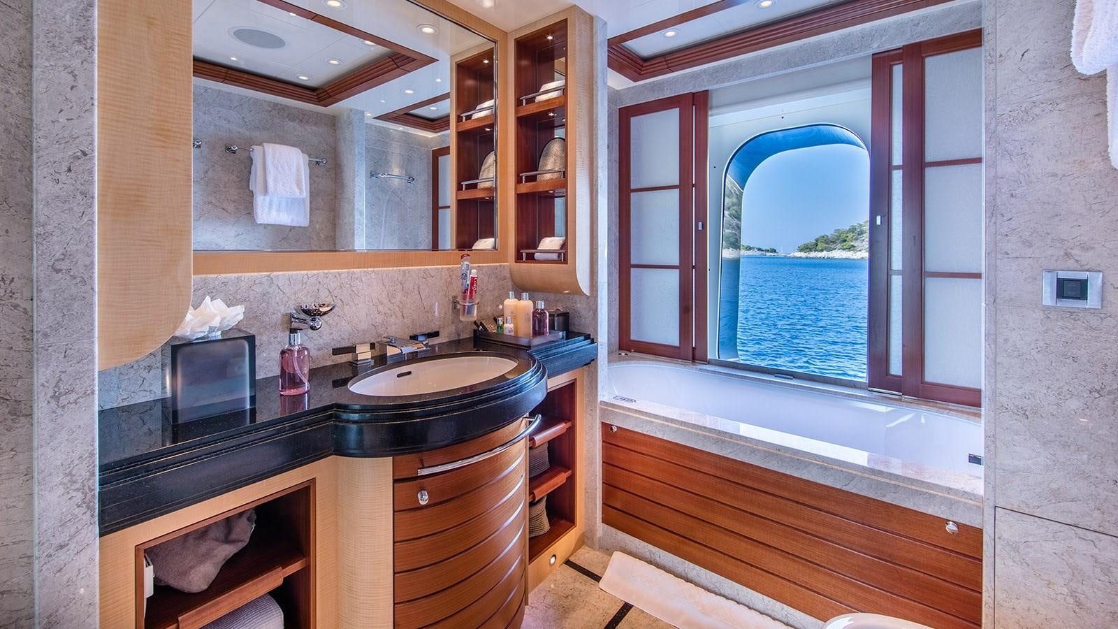 a bathroom with a sink and a window aboard RARE FIND Yacht for Sale