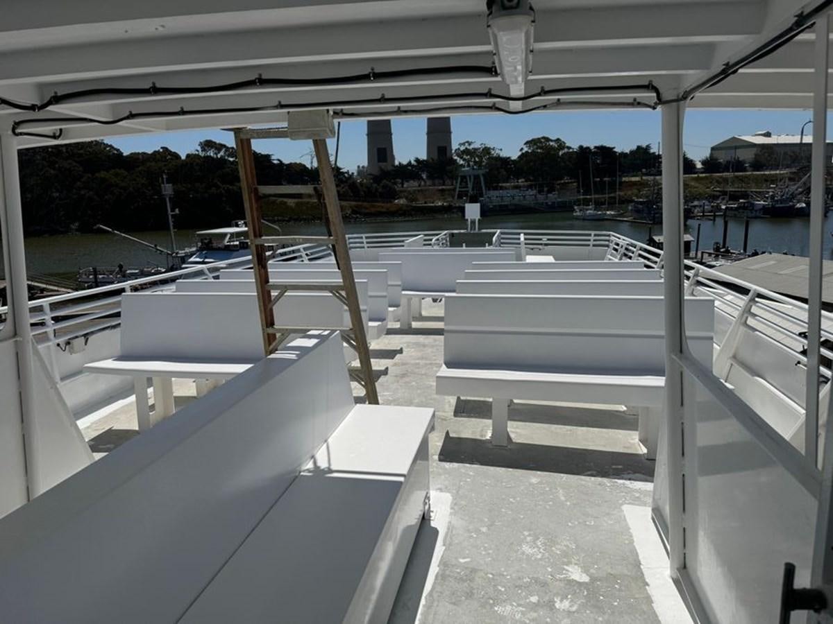 a deck with a railing and a railing with a body of water in the background aboard OCEAN THUNDER Yacht for Sale