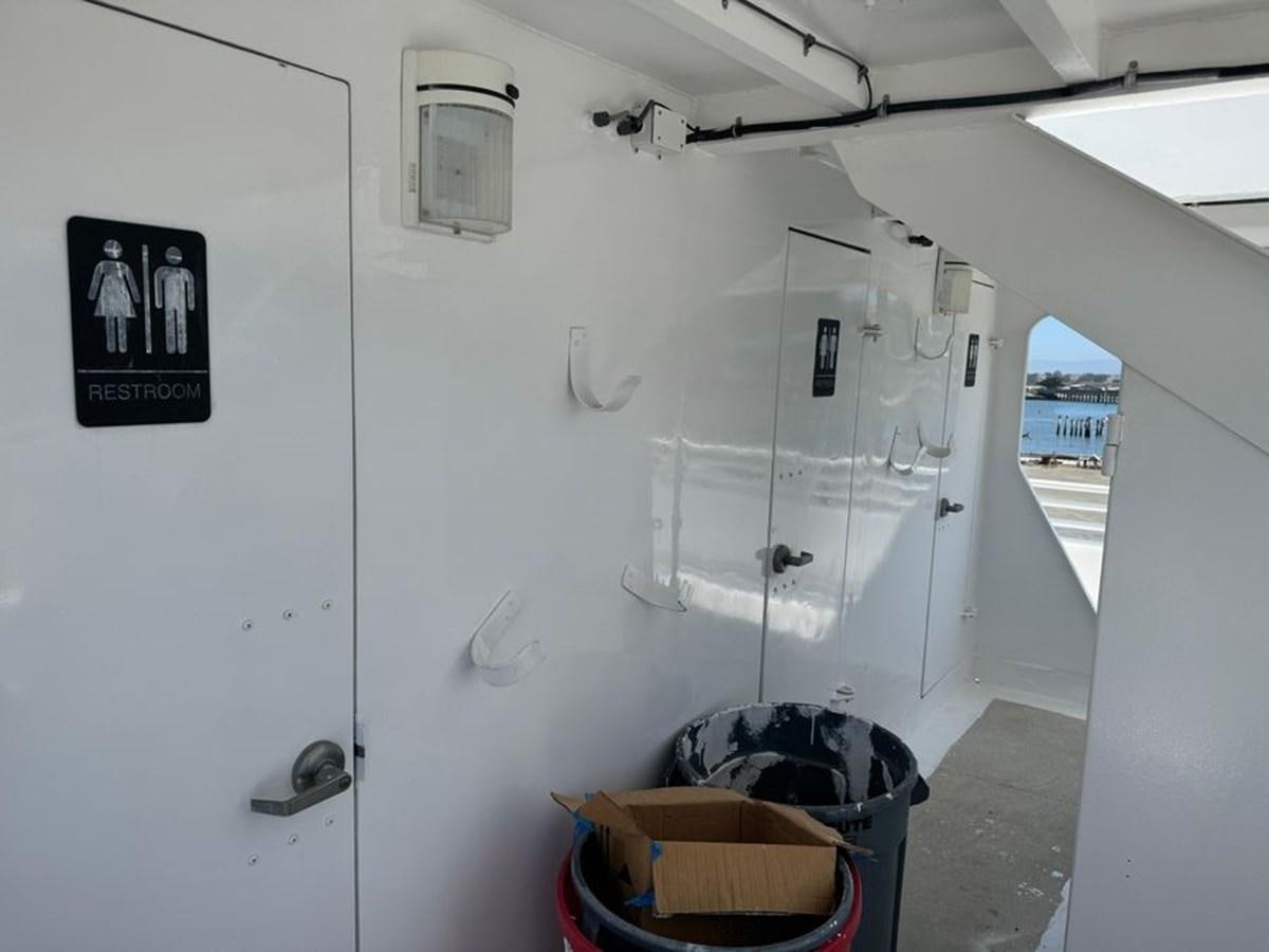 a white wall with a trash can and a trash can in it aboard OCEAN THUNDER Yacht for Sale