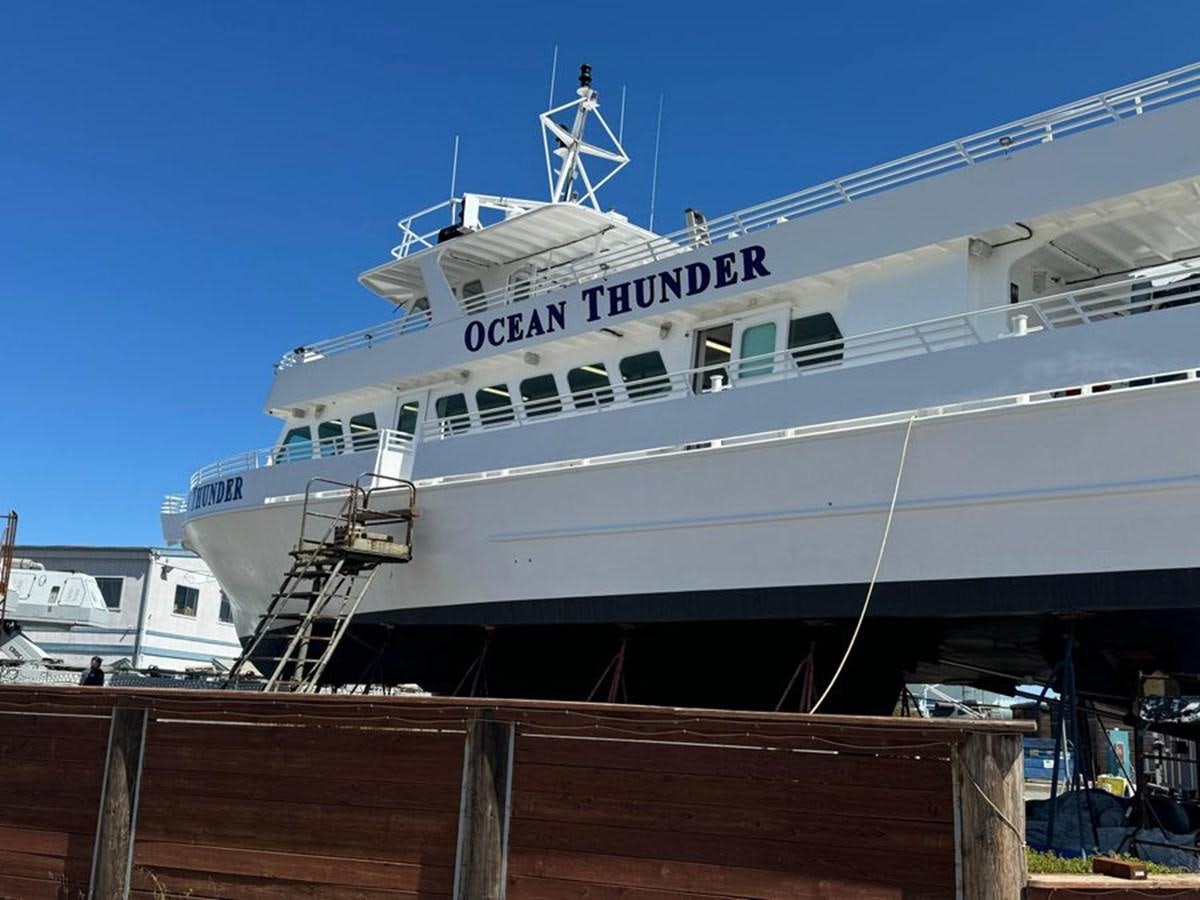 a large white ship docked aboard OCEAN THUNDER Yacht for Sale