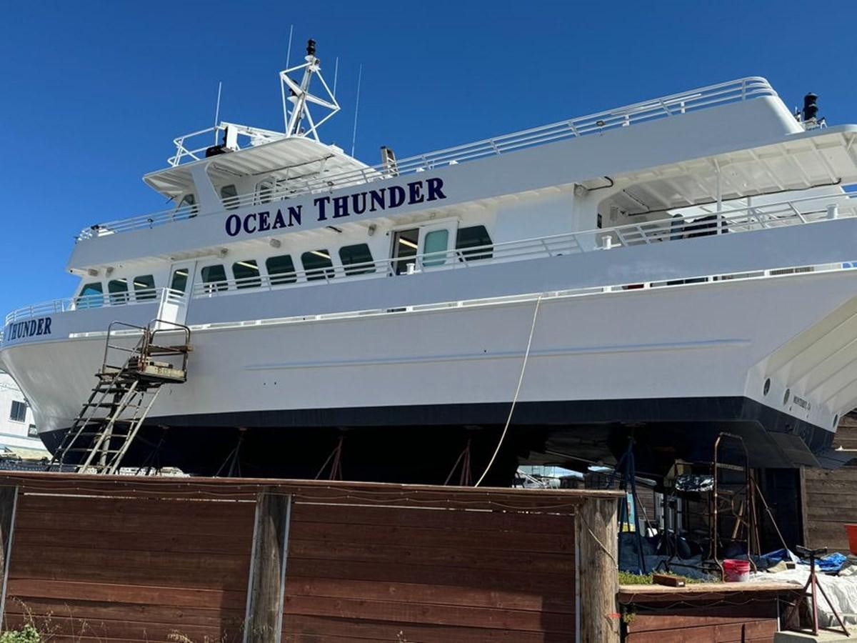 a large white ship docked aboard OCEAN THUNDER Yacht for Sale