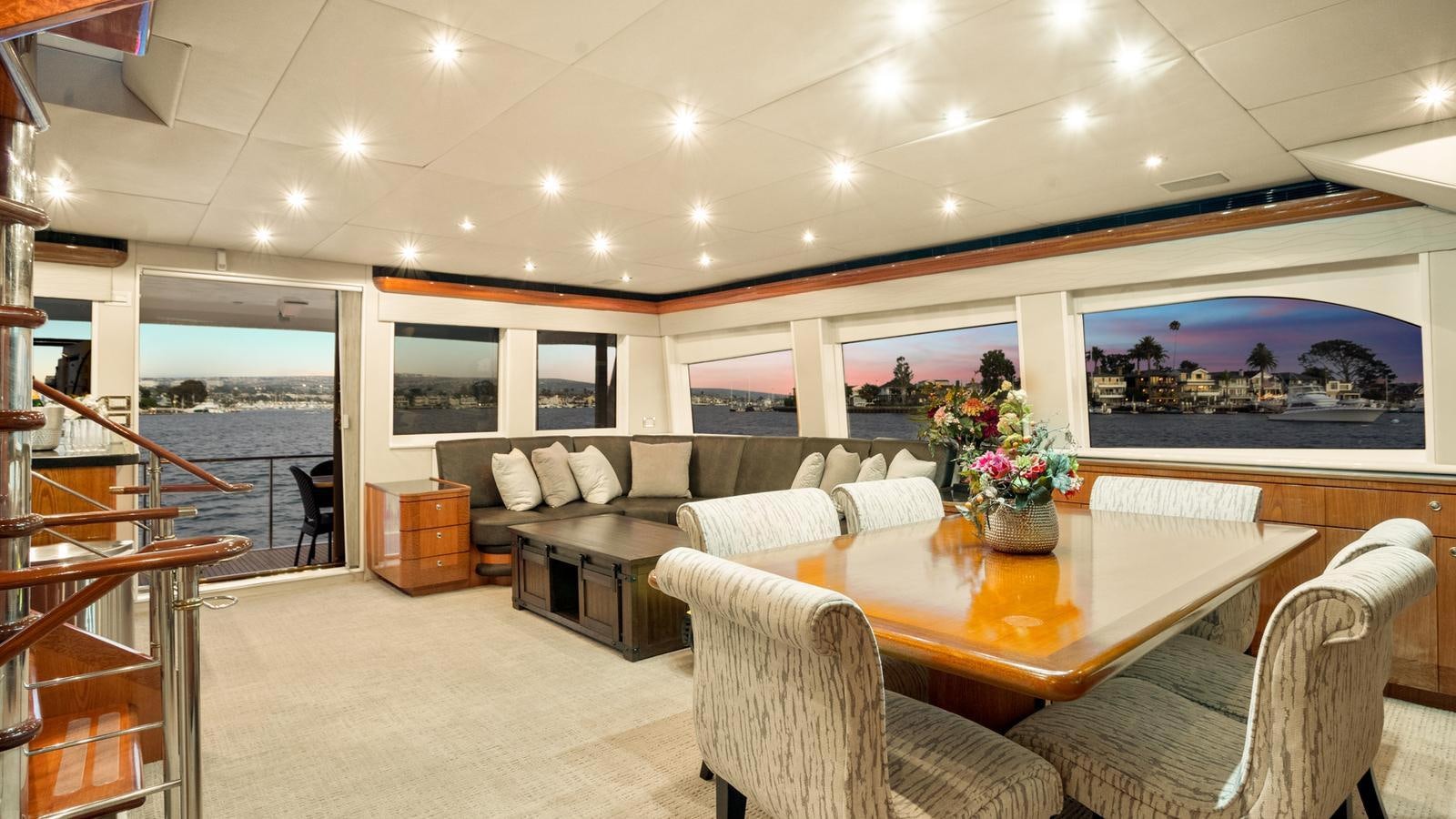 a large living room with a large table and chairs aboard ANGELICA Yacht for Sale