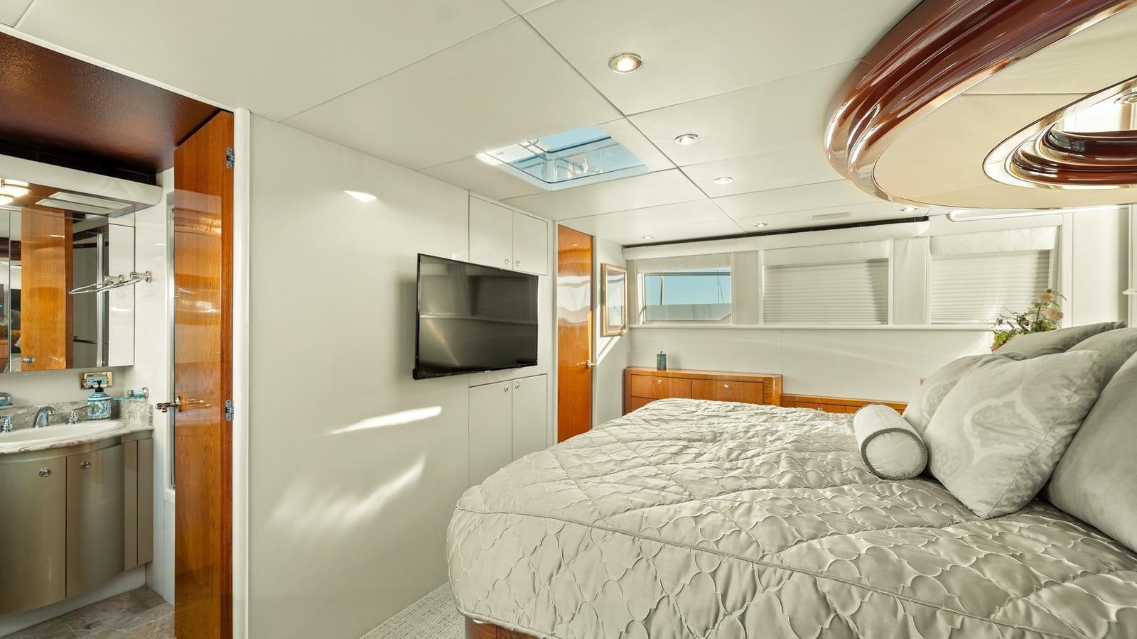 a bedroom with a bed and a television aboard ANGELICA Yacht for Sale