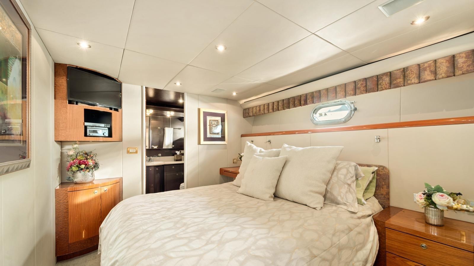 a bedroom with a bed and a tv aboard ANGELICA Yacht for Sale