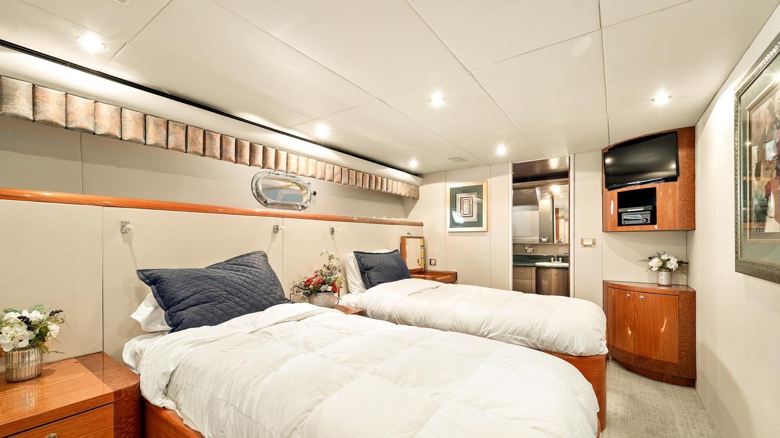 a room with a bed and a television aboard ANGELICA Yacht for Sale