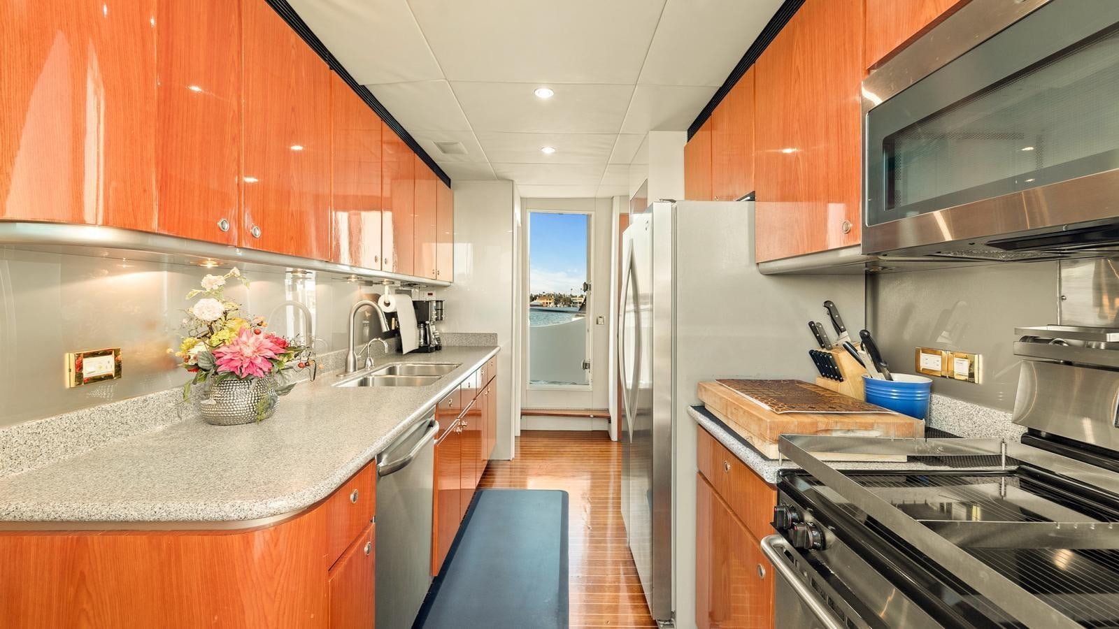 a kitchen with wooden cabinets aboard ANGELICA Yacht for Sale