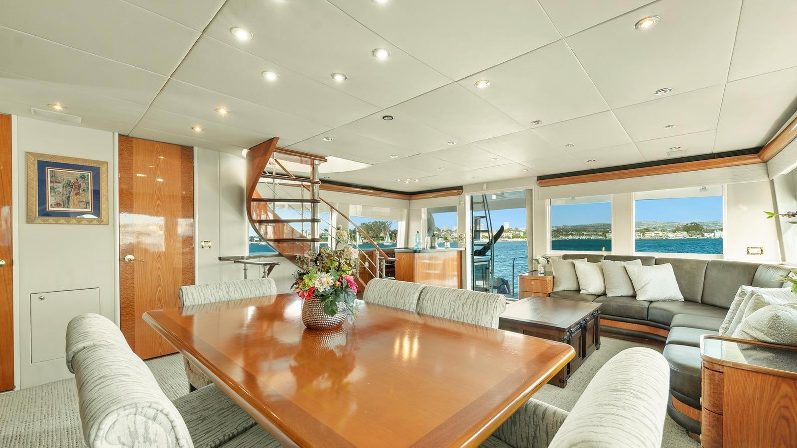 a living room with a table and couches aboard ANGELICA Yacht for Sale