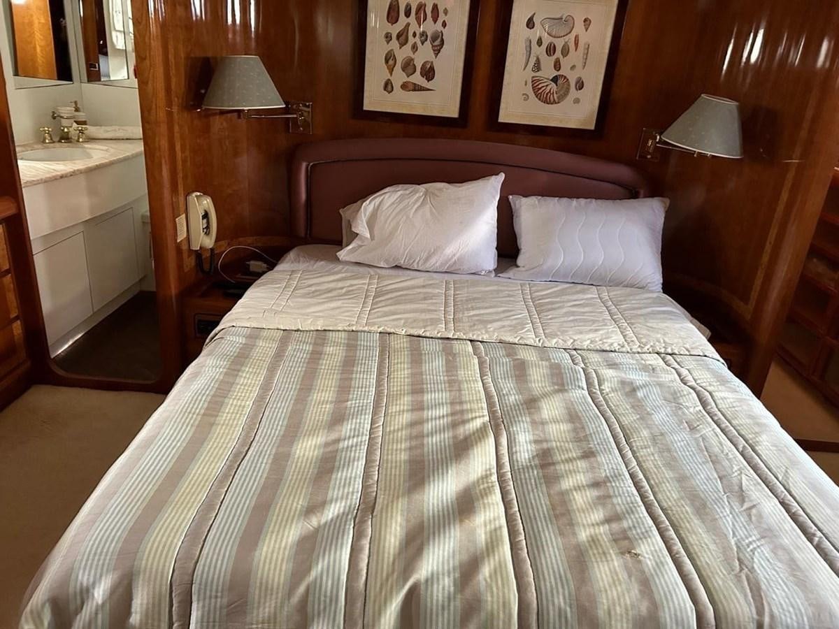 a bed with white sheets aboard MILMAR Yacht for Sale