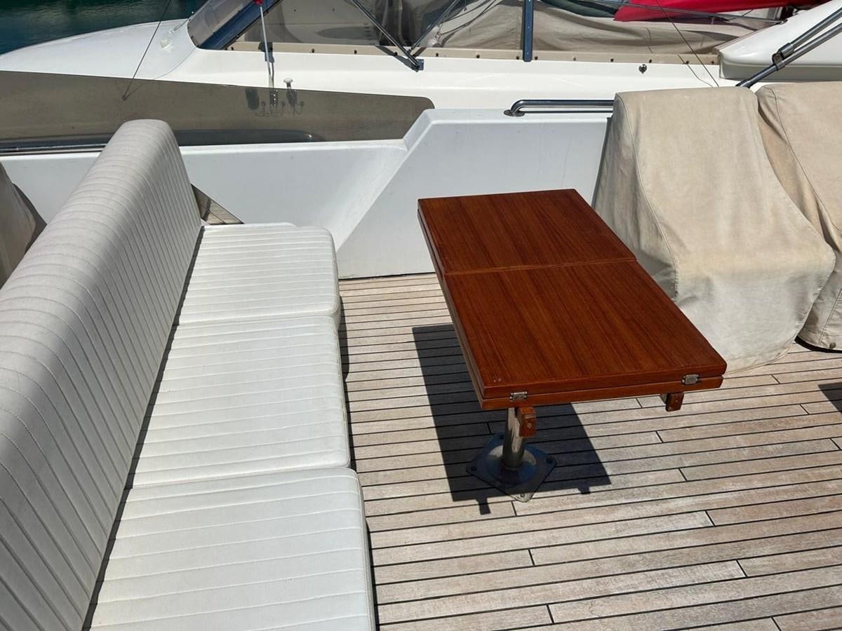 a wooden table on a wooden floor aboard MILMAR Yacht for Sale