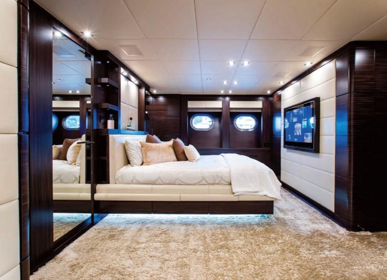 a room with a bed and a tv on the wall aboard GENESIS Yacht for Sale