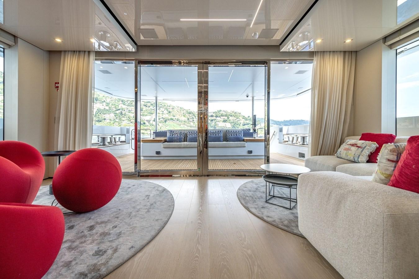 a living room with a large window aboard RSY C.129 Yacht for Sale