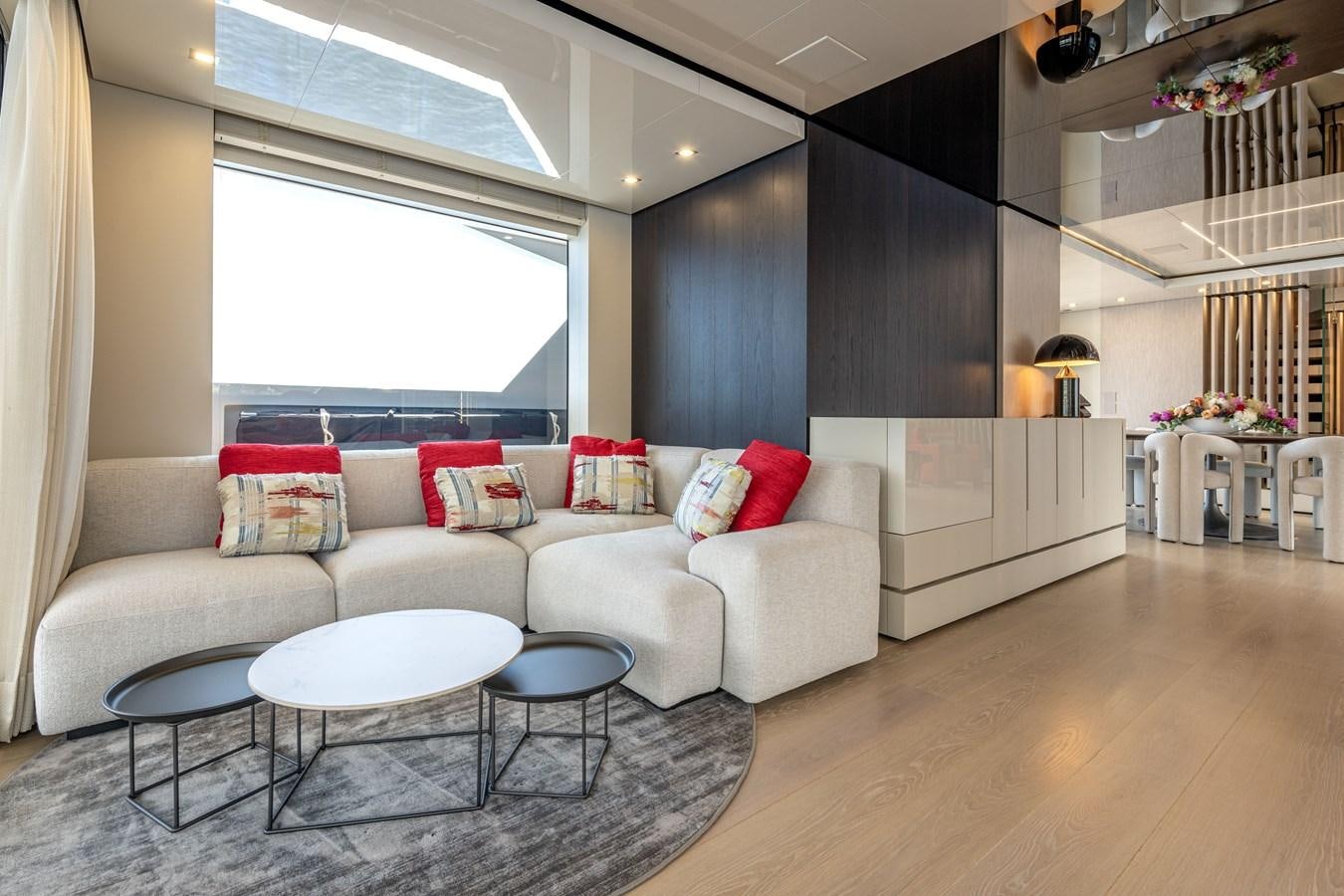 a living room with a white couch and a table aboard RSY C.129 Yacht for Sale