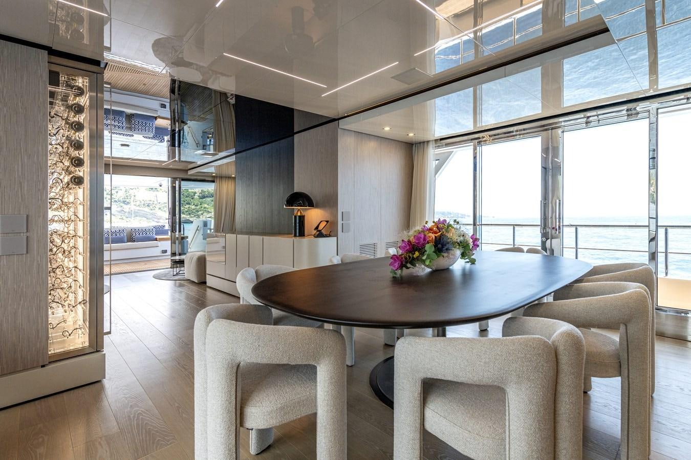 a large dining table in a room aboard RSY C.129 Yacht for Sale