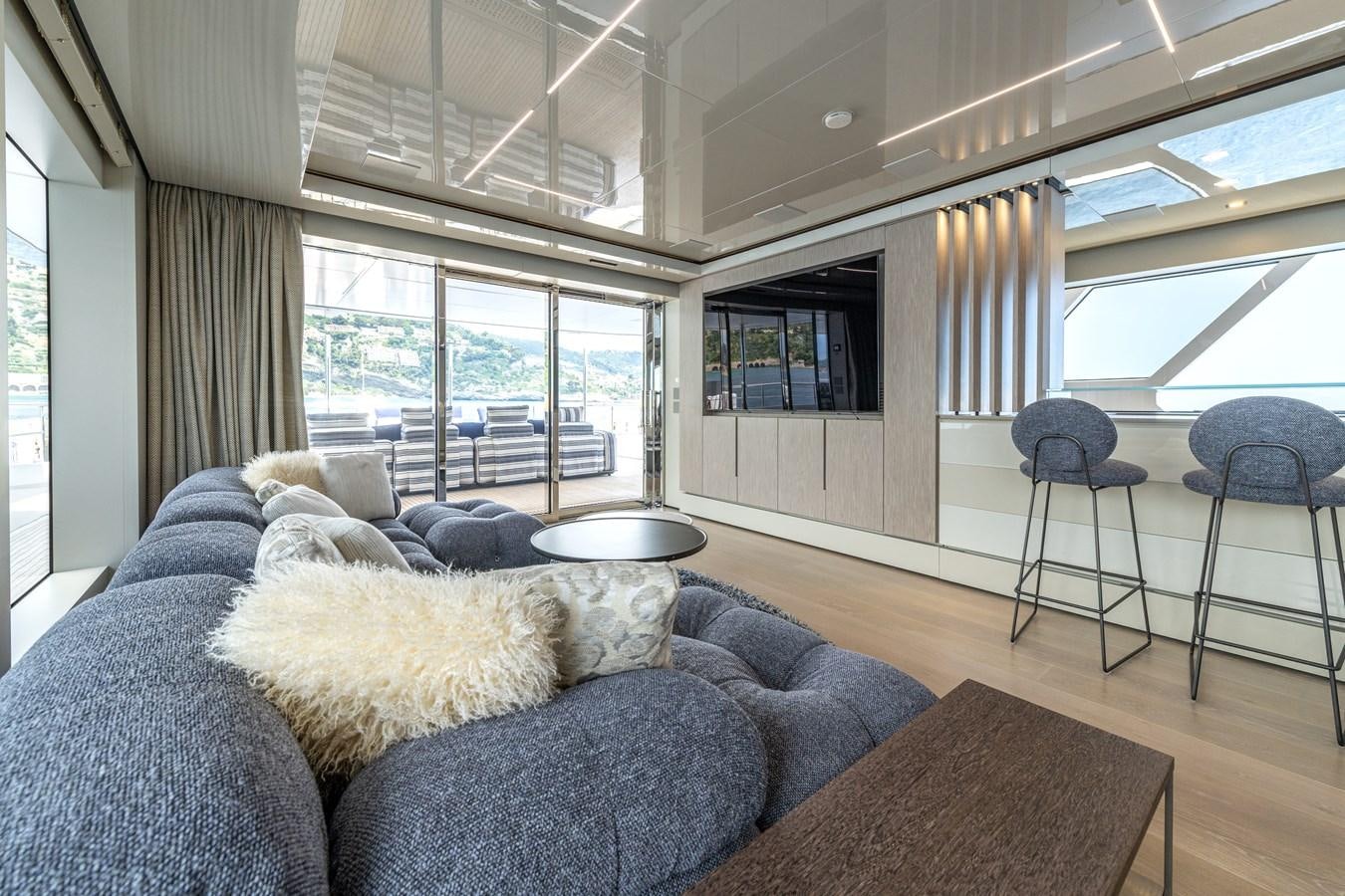 a dog lying on a couch aboard RSY C.129 Yacht for Sale
