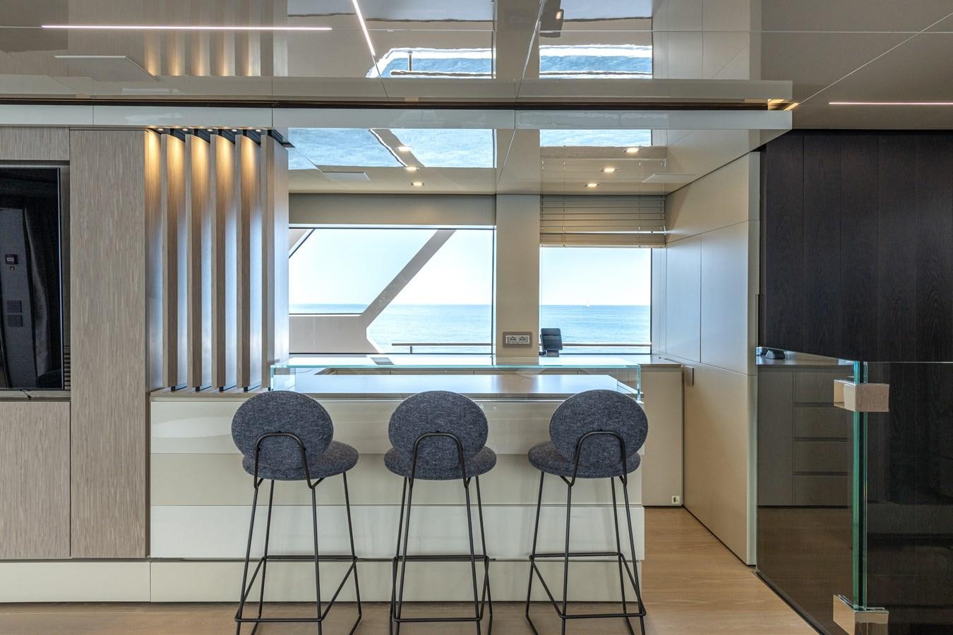 a room with chairs and a table aboard RSY C.129 Yacht for Sale