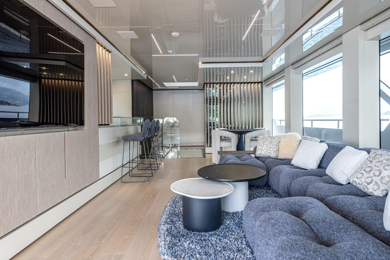 a living room with a couch and a table aboard RSY C.129 Yacht for Sale