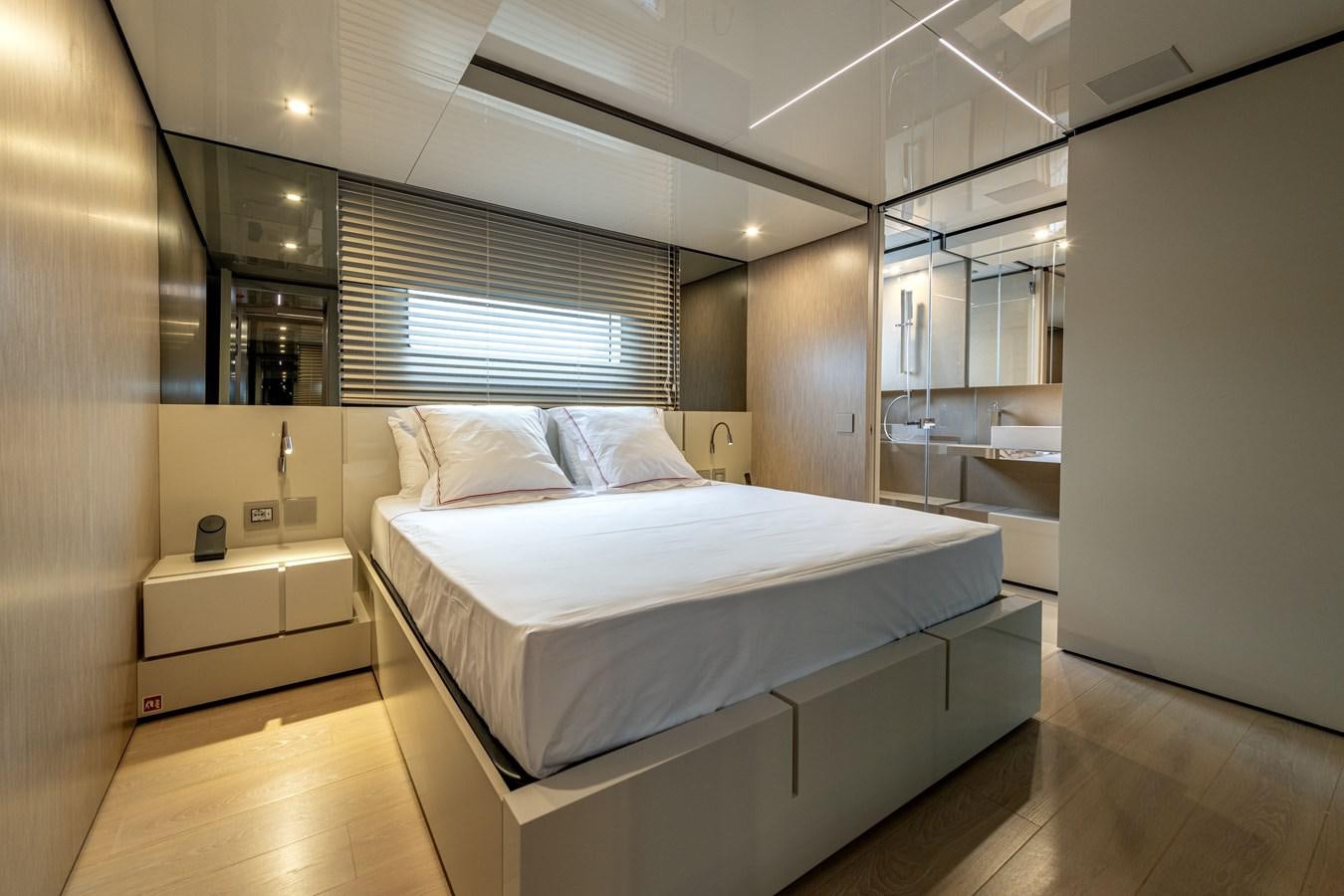 a bedroom with a bed and a window aboard RSY C.129 Yacht for Sale