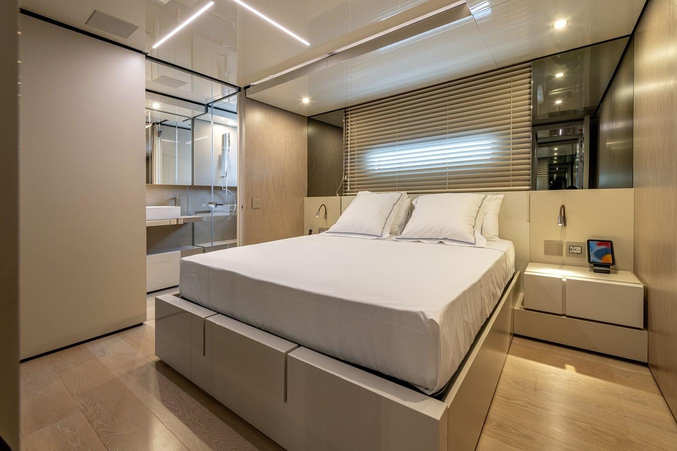 a large bedroom with a large bed aboard RSY C.129 Yacht for Sale