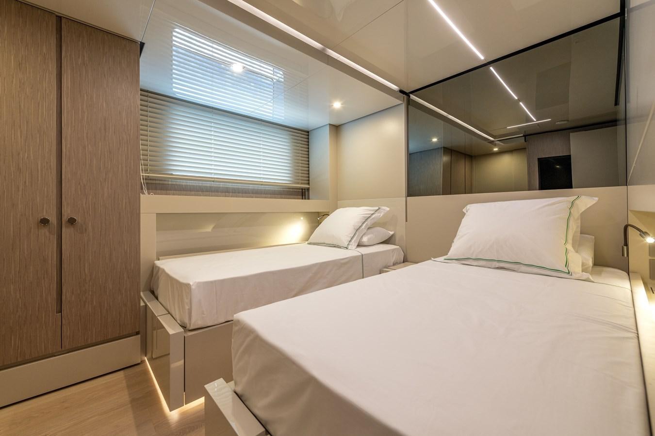 a room with two beds aboard RSY C.129 Yacht for Sale