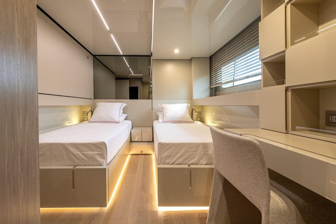 a room with a couple of beds aboard RSY C.129 Yacht for Sale
