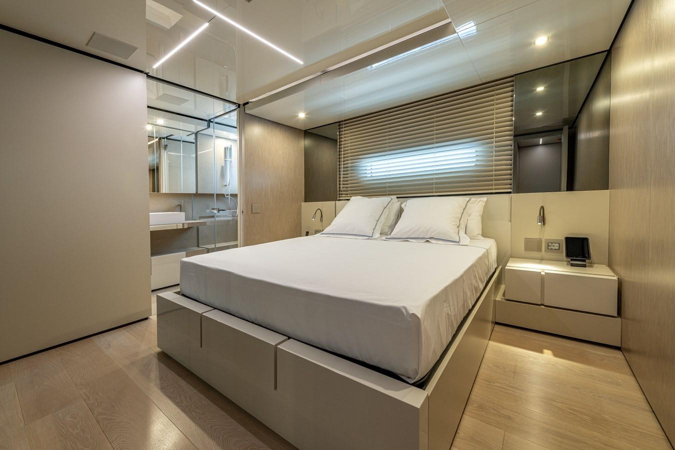 a room with a bed and a window aboard RSY C.129 Yacht for Sale