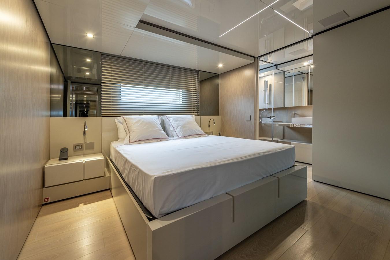 a room with a bed and a window aboard RSY C.129 Yacht for Sale