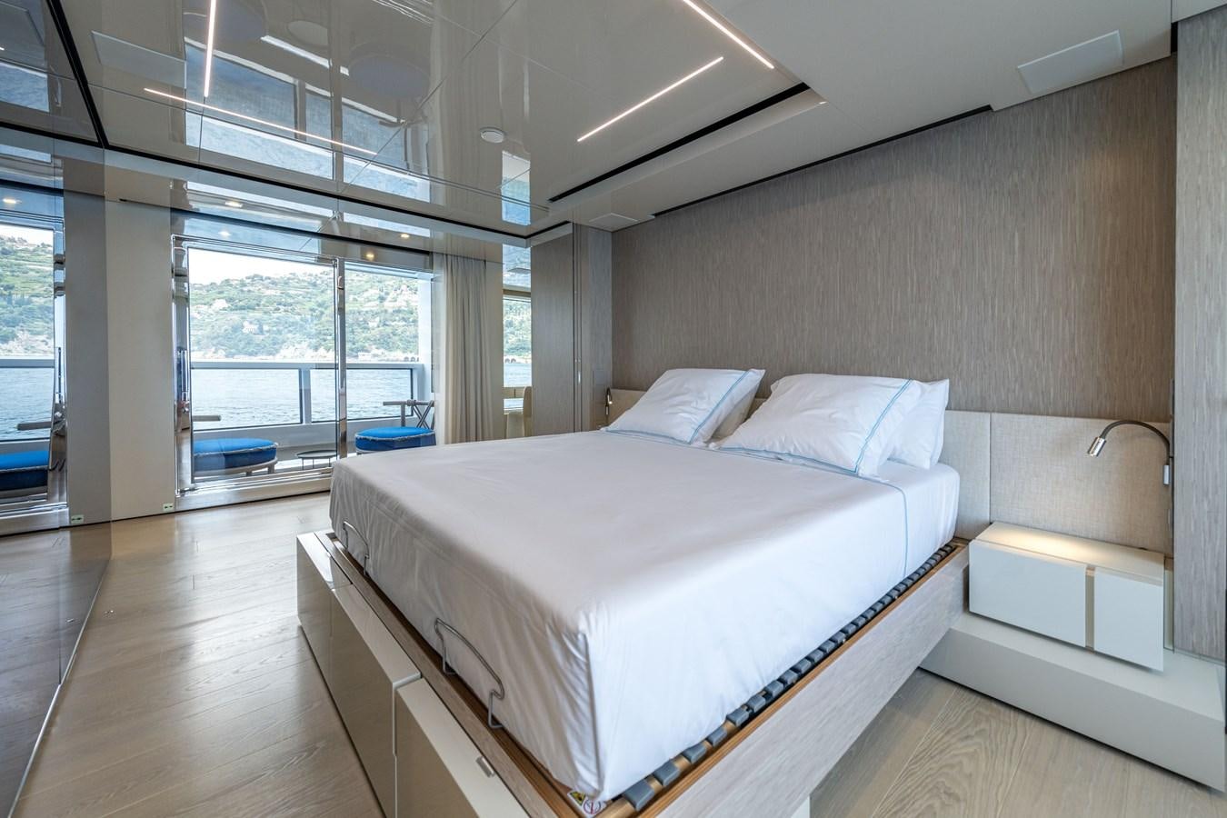 a room with a bed and a window aboard RSY C.129 Yacht for Sale