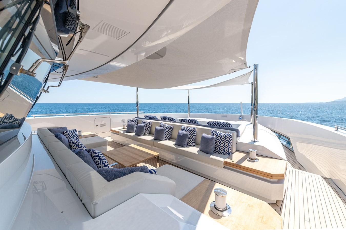 a room with a couch and a table and a window aboard RSY C.129 Yacht for Sale
