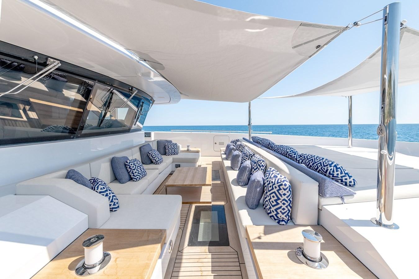 a room with a bed and a table aboard RSY C.129 Yacht for Sale