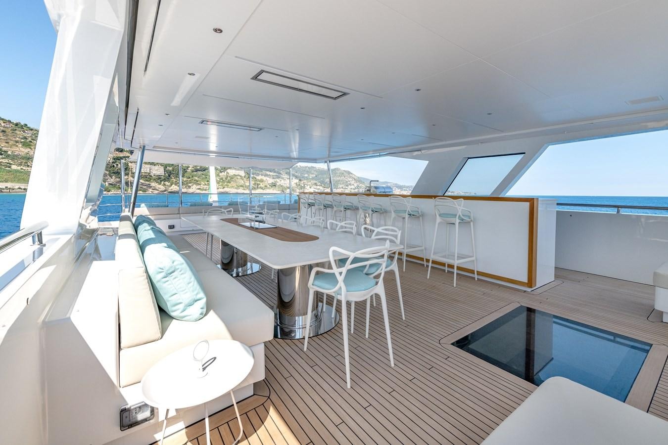 a room with a deck and a pool aboard RSY C.129 Yacht for Sale