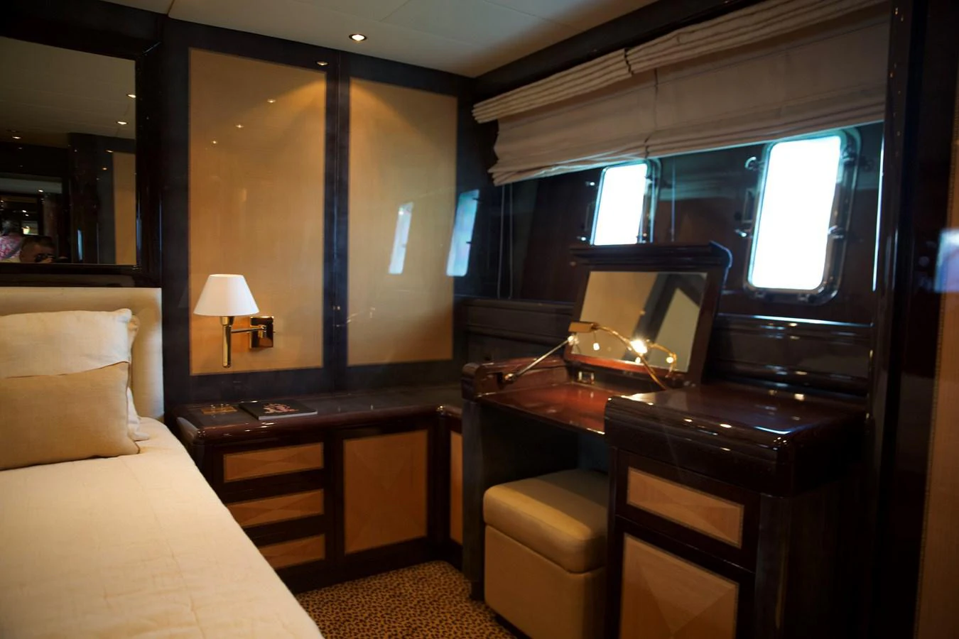 a bedroom with a bed desk and a television aboard SILVER SKY Yacht for Sale