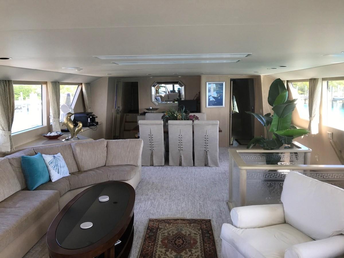 a living room with a laptop on the table aboard MON SHERI Yacht for Sale